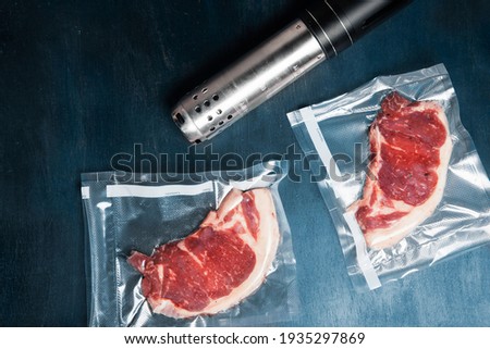 Two vacuum packed beef steaks with a sous vide roner. Low temperature cooking concept
