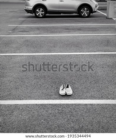 abandoned shoes on the parking lot
