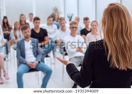 rear view. female speaker giving a lecture in the conference room. Royalty-Free Stock Photo #1935394009