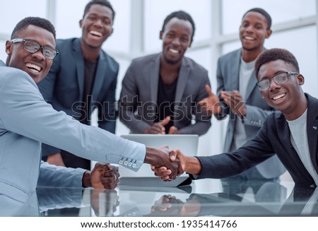 reliable handshake of business partners over the desktop. Royalty-Free Stock Photo #1935414766