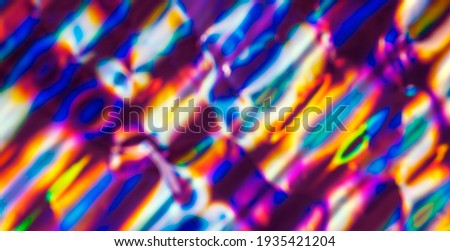 Out of focus photo lens overlays heavy grain noise abstract holographic vivid colorful texture background.