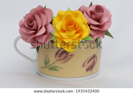 Handmade rose flowers made from origami decorated in a cup