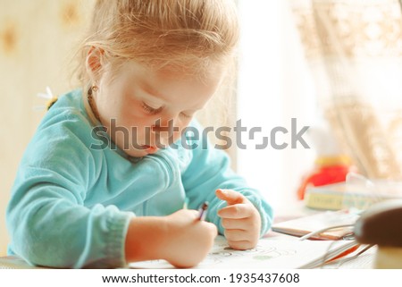 Child preschooler painting in classroom. Child care.