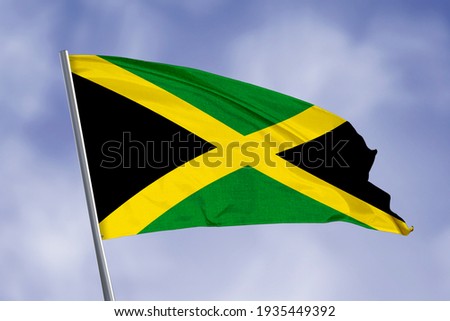 Jamaica flag isolated on sky background. close up waving flag of Jamaica. flag symbols of Jamaica.