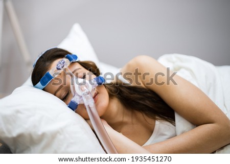 Sleep Apnea Oxygen Mask Equipment And CPAP Machine Royalty-Free Stock Photo #1935451270