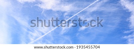 background of beautiful bright blue day sky with white cloud and trail from the plane. banner