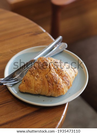 Cheese Coissant on the table. Bakery on blue plate. 