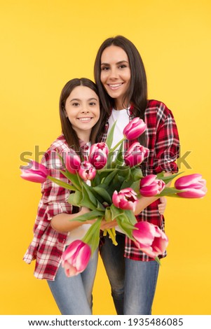 happy mothers and womens day. spring flower bouquet gift. childhood and motherhood. love and friendship. happy family day. teen girl with mom. 8 march holiday. mother and daughter with tulip flowers.