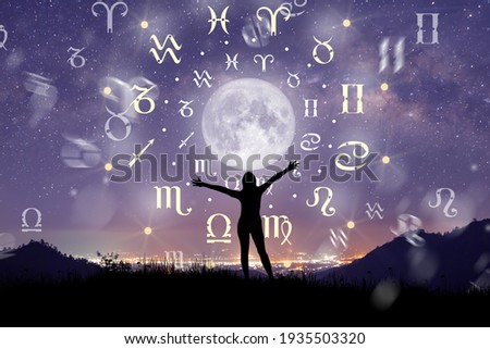 Astrological zodiac signs inside of horoscope circle. Illustration of Woman silhouette consulting the stars and moon over the zodiac wheel and milky way background. The power of the universe concept. Royalty-Free Stock Photo #1935503320