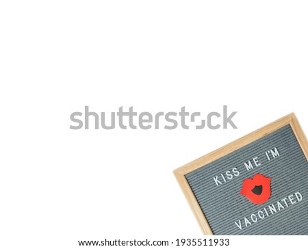 Top view on letterboard with words Kiss me im vaccinated, white background