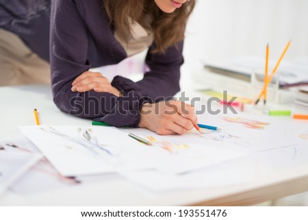 Closeup on fashion designer working in office