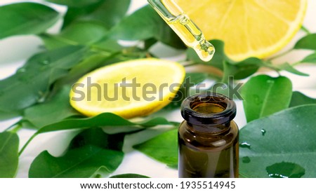 lemon essential oil in small bottles. selective focus. Nature