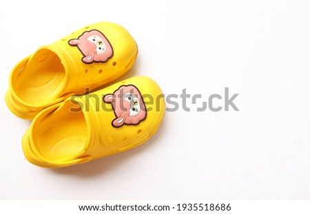 copy space Yellow baby rubber shoes isolate on white background