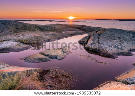 Sunset on skerries in Ytre Hvaler National Park, on the island of Kirkeoy in Norway Royalty-Free Stock Photo #1935535072