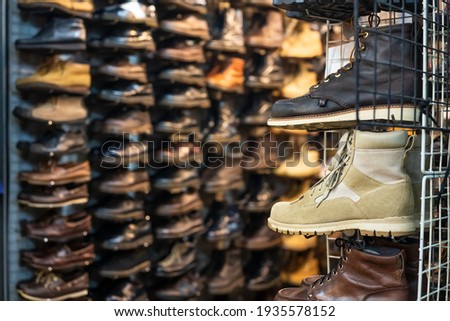 second hand shoes on display on shelves ,in front of shoe store at Chatuchak weekend Market, Bangkok.

