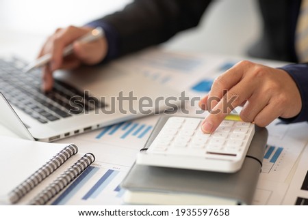  Businessmen are calculating income-expenditure and analyzing real estate investment data, Accounting Financial and tax systems concept. Royalty-Free Stock Photo #1935597658