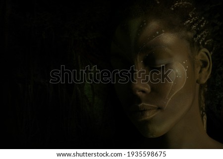 Art photo of Africal woman with tribal ethnic paintings on her face