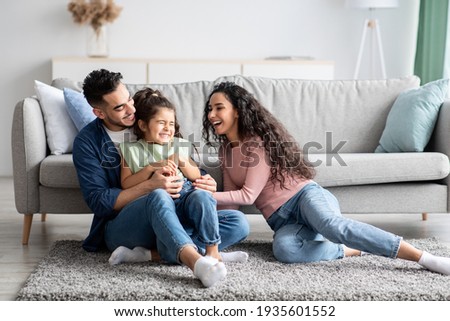 Middle Eastern Parents Having Fun With Their Little Daughter At Home Royalty-Free Stock Photo #1935601552