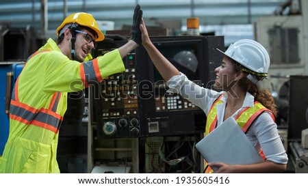 Professional  team engineering Man Worker at industrial factory wearing uniform and hardhats at Metal lathe industrial manufacturing factory. Engineer Operating lathe Machinery Royalty-Free Stock Photo #1935605416