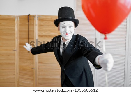 Mime artist with air balloon, comedy parody