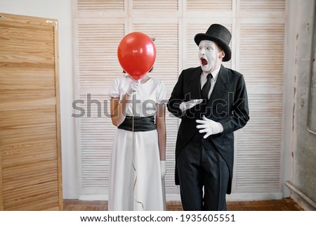 Two mime artists with air balloon, comedy parody