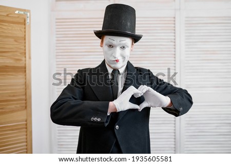 Male mime artist, love heart gesture, parody