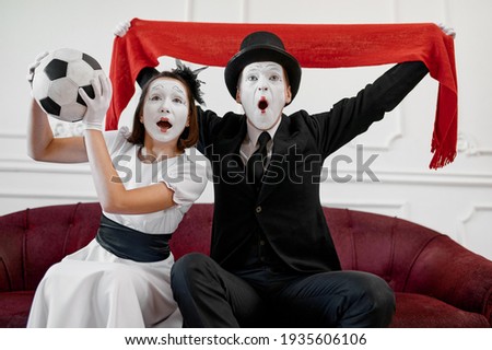 Two mime artists, football fans parody
