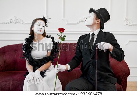 Two mime artists, love couple, scene with rose
