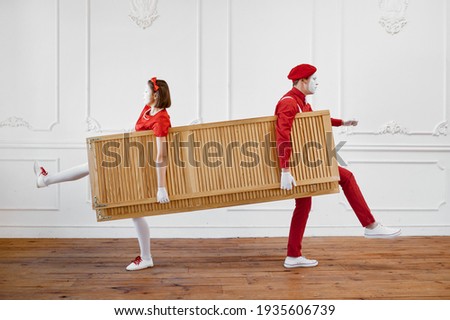 Two mime artists, clowns with wooden partition