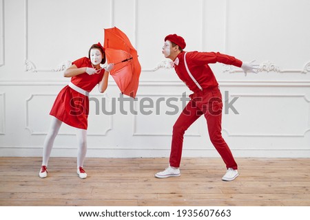 Mime artists, scene with umbrella in windy weather