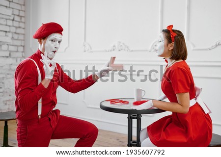Male and female mime artists, scene with gift