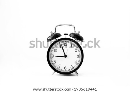 Black alarm clock isolated on white background. 9 o'clock. Morning, reminder. Time concept Royalty-Free Stock Photo #1935619441