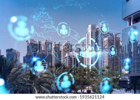 Panoramic view skyscrapers. Modern cityscape of the capital of the Emirate of Dubai. Recruitment and social relation concept. Double exposure. Royalty-Free Stock Photo #1935621124