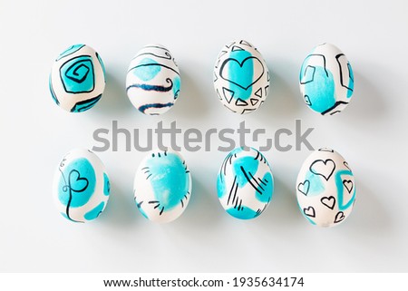 Creative trendy painted easter eggs on white background. Easter ideas.