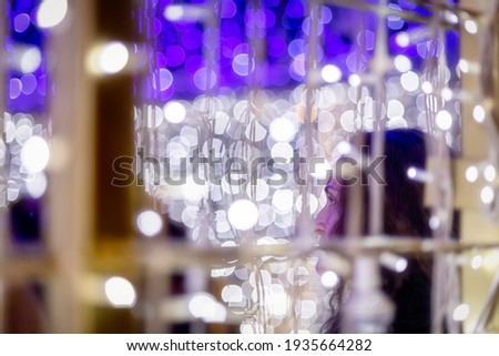 Woman in her forties among the decorative lights of the city. High resolution and quality photography.