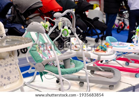 Baby swing rocker for sale in the store. Royalty-Free Stock Photo #1935683854