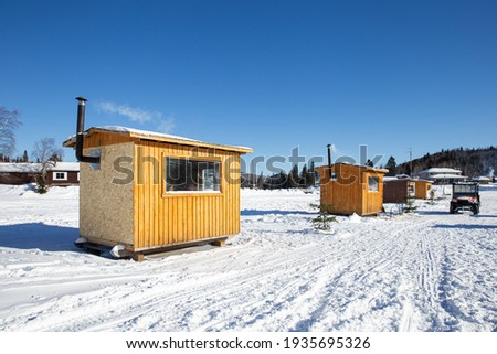 small houses for warming up while ice fishing Royalty-Free Stock Photo #1935695326