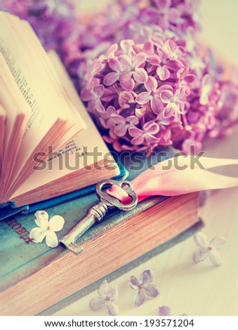 Nostalgic vintage background/ Vintage books,Photos of Memories and key with lilac flower