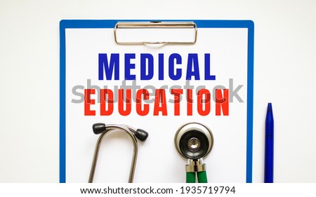 Clipboard with page and text MEDICAL EDUCATION, on a table with a stethoscope and pen. medical concept.