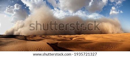 Starting sand storm in desert of high altiude with cumulonimbus rain louds.