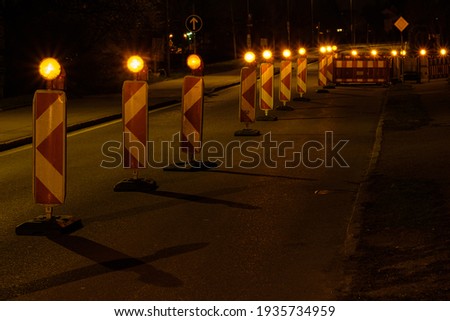Roadworks construction with warning lights in the night