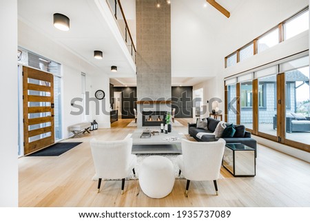 Large open concept great room with fireplace and wooden beams Royalty-Free Stock Photo #1935737089