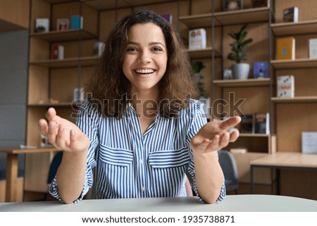 Happy latin young woman online tutor, remote school teacher or student talking to camera at virtual class making video call looking at web cam having distance meeting, recording video presentation. Royalty-Free Stock Photo #1935738871
