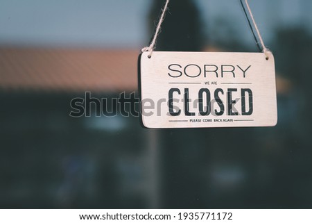 Vintage sorry we are closed at the glass door of a coffee shop, restaurant, shop, during the outbreak of the virus protection.

