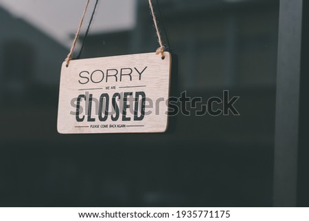 Vintage sorry we are closed at the glass door of a coffee shop, restaurant, shop, during the outbreak of the virus protection.
