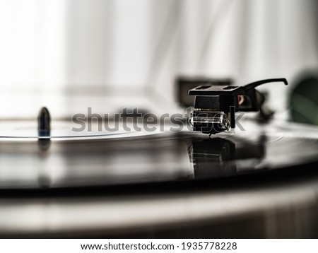 Turntable plays a vinyl record  Royalty-Free Stock Photo #1935778228