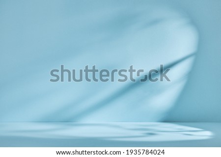 Abstract blue background with drop shadow and light. Backdrop for product presentation Royalty-Free Stock Photo #1935784024