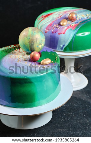 Mousse cake with a coating of icing. Cake with abstract patterns and balls. Cake of high confectionery art