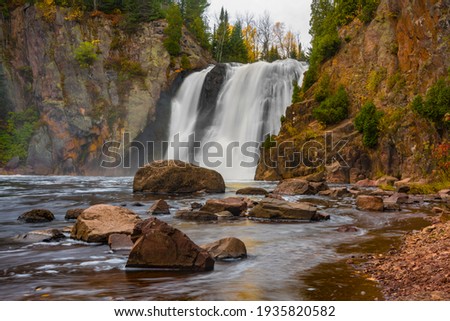 The High Falls of the Baptism River on an autumn day at Tettegouche State Park, Minnesota. Royalty-Free Stock Photo #1935820582