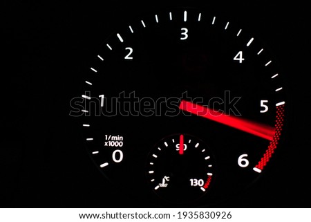 Close up of car dashboard tachometer on blackground. 5000 - 6000 rpm.            Royalty-Free Stock Photo #1935830926